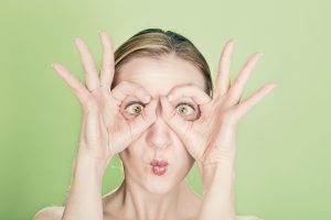 woman using hands as glasses - healthy eyes