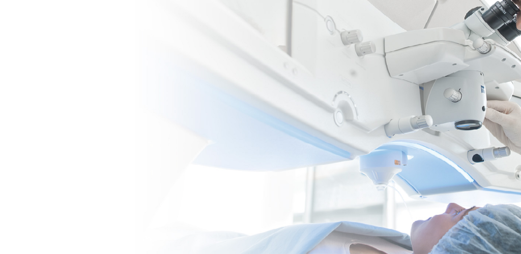 A person laying on a surgery bed under a zeiss visumax laser about to have laser eye surgery