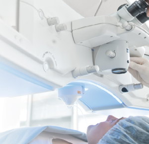 A person laying on a surgery bed under a zeiss visumax laser about to have laser eye surgery