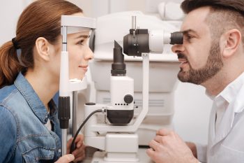 woman having eye check from a male technician